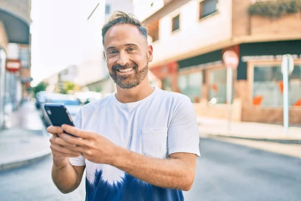 Středního Věku Hezký Muž Usměvavý Šťastný Pomocí Smartphone Městě — Stock fotografie