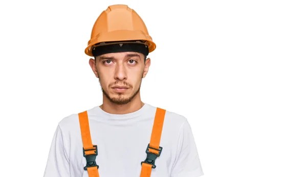 Hispanischer Junger Mann Handwerkeruniform Und Schutzhelm Mit Ernstem Gesichtsausdruck Einfacher — Stockfoto