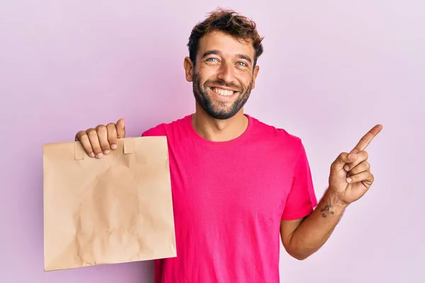 Handsome Man Beard Holding Take Away Paper Bag Smiling Happy — Stock Photo, Image