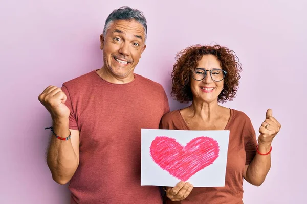 Beautiful Middle Age Couple Holding Heart Draw Screaming Proud Celebrating — Stock Photo, Image