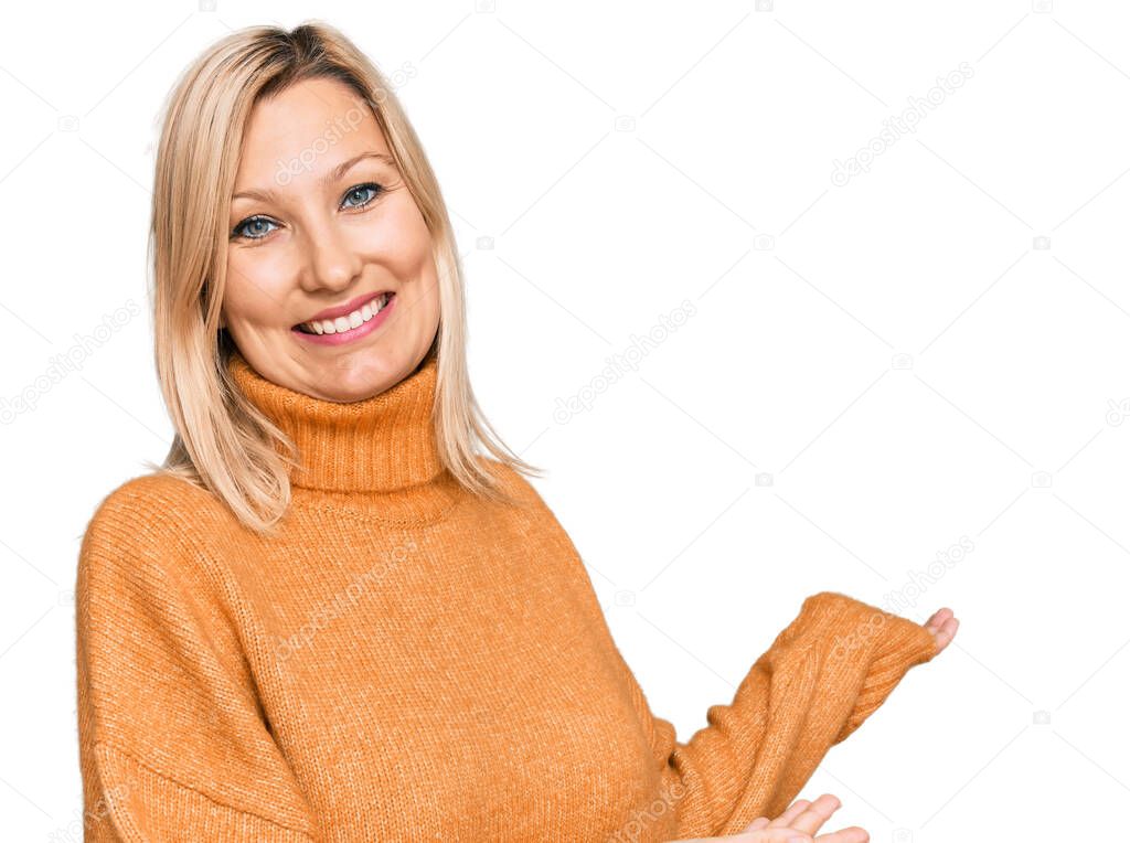 Middle age caucasian woman wearing casual winter sweater inviting to enter smiling natural with open hand 