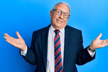 Senior caucasian man wearing business suit and tie smiling showing both hands open palms, presenting and advertising comparison and balance 