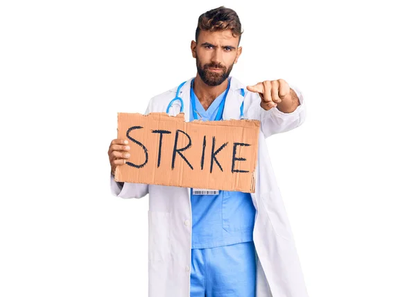 Young Hispanic Man Wearing Doctor Stethoscope Holding Strike Banner Pointing — Stock Photo, Image