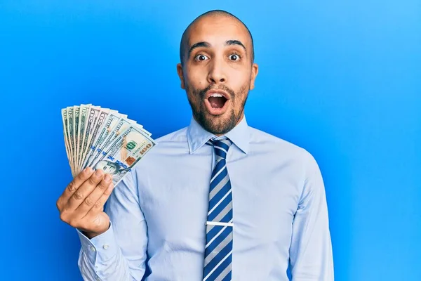 Hispanic Adult Business Man Holding Dollars Scared Amazed Open Mouth — Stock Photo, Image