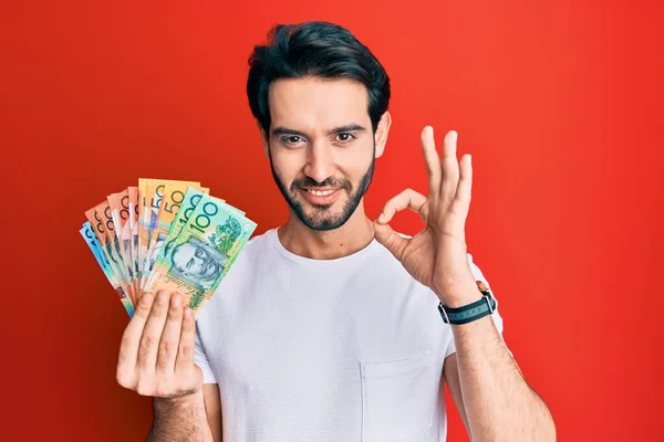 Ung Latinamerikansk Man Håller Australiska Dollar Gör Tecken Med Fingrar — Stockfoto