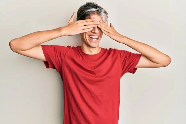 Mladý Hispánec Neformálním Oblečení Zakrývajícím Oči Veselýma Legračníma Rukama Slepý — Stock fotografie