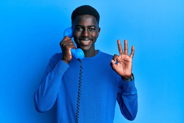 Młody Afrykanin Amerykański Człowiek Gospodarstwa Vintage Telefon Robi Znak Palcami — Zdjęcie stockowe