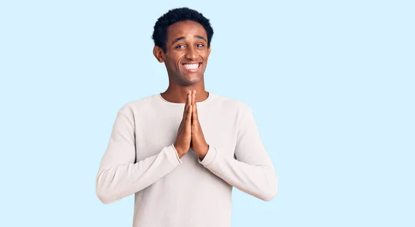 African Handsome Man Wearing Casual Winter Sweater Praying Hands Together — Stock Photo, Image
