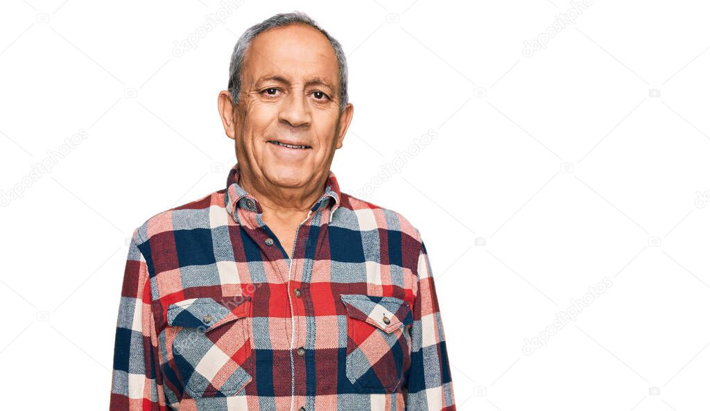 Senior hispanic man wearing casual clothes looking positive and happy standing and smiling with a confident smile showing teeth 