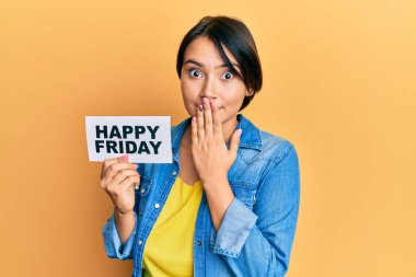 Kısa saçlı güzel bir kadın, elinde mutlu bir cuma mesajı kâğıdıyla ağzını eliyle kapatıyor, şok geçiriyor ve hata yapmaktan korkuyor. şaşırmış ifade 