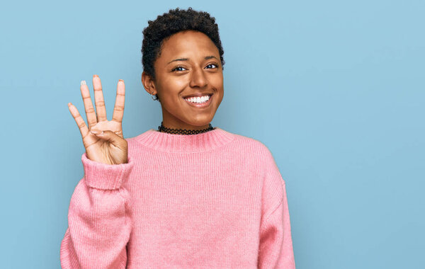 Young african american woman wearing casual clothes showing and pointing up with fingers number four while smiling confident and happy. 