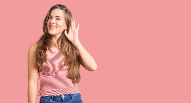 Gündelik giysiler giymiş, el pençe divan gülümseyen, dedikoduları ve dedikoduları dinleyen güzel beyaz bir kadın. Sağırlık kavramı. 