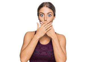 Spor giyimli güzel sarışın kadın yanlışlıkla elleri ile ağzını kapatırken şok oldu. gizli kavram. 