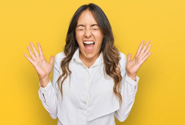 Genç esmer kadın gündelik giysiler giyip başarının çılgınlığını kutluyor. Kollarını kaldırmış, gözlerini kapatmış heyecanlı çığlıklar atıyor. Kazanan konsept 