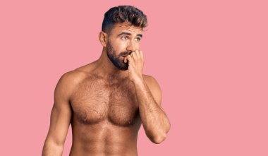 Mayo giyen genç İspanyol bir adam stresli ve gergin görünüyor. Ağzı tırnak yiyen elleri var. anksiyete. 