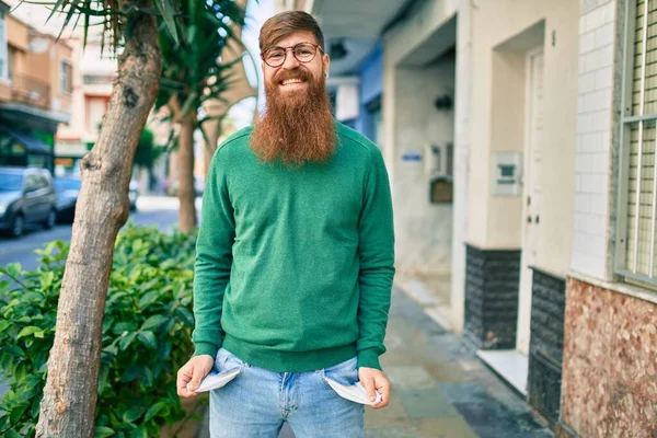 Jovem Irlandês Com Barba Ruiva Sorrindo Feliz Mostrando Seus Bolsos — Fotografia de Stock