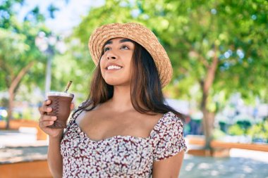 Genç Latin kadın tatilde. Bir fincan çay içiyor. Şehir caddesinde yürüyor..