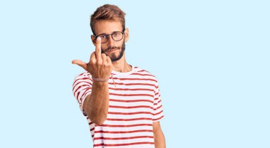 Handsome blond man with beard wearing casual clothes and glasses showing middle finger, impolite and rude fuck off expression 