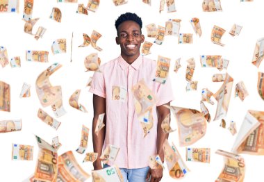 Genç Afro-Amerikalı sıradan kıyafetler giymiş, kameraya seksi bir ifadeyle bakıyor, neşeli ve mutlu bir yüzle..