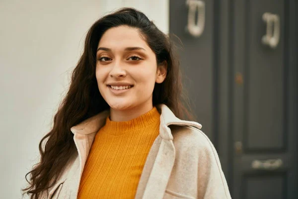 Young middle east woman smiling happy standing at the city.