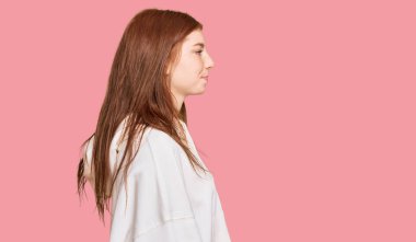 Genç, okumuş, günlük kazak giyen, rahat bir görünüm takınan, kendine güvenen gülümseyen bir kadın.. 