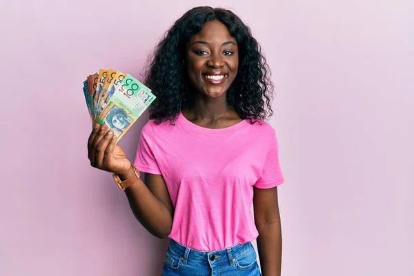 Beautiful African Young Woman Holding Australian Dollars Looking Positive Happy — Foto de Stock