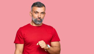 Orta yaşlı, sıradan kıyafetler giyen, kendini kötü hisseden ve soğuk algınlığı veya bronşitin belirtisi olarak öksüren yakışıklı bir adam. sağlık hizmeti kavramı. 