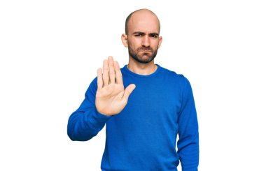 Günlük kıyafetler giyen genç İspanyol adam avucunun içi gibi şarkı söylemeyi kesiyor. Yüzünde olumsuz ve ciddi bir jest olan uyarı ifadesi. 