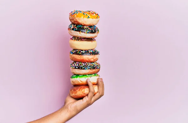 Hand Hispanic Man Holding Tower Donuts Isolated Pink Background — Stock Photo, Image