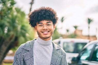 Genç Afrikalı Amerikalı işadamı parkta mutlu bir şekilde dikiliyor.