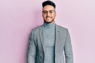 Young arab man wearing business clothes with a happy and cool smile on face. lucky person. 