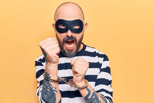 Young Handsome Man Wearing Burglar Mask Handcuffs Annoyed Frustrated Shouting — Stock Photo, Image