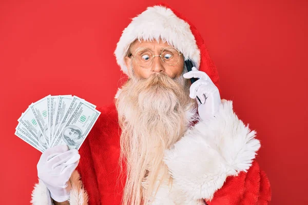 Velho Homem Sênior Vestindo Traje Papai Noel Segurando Dólares Smartphone — Fotografia de Stock