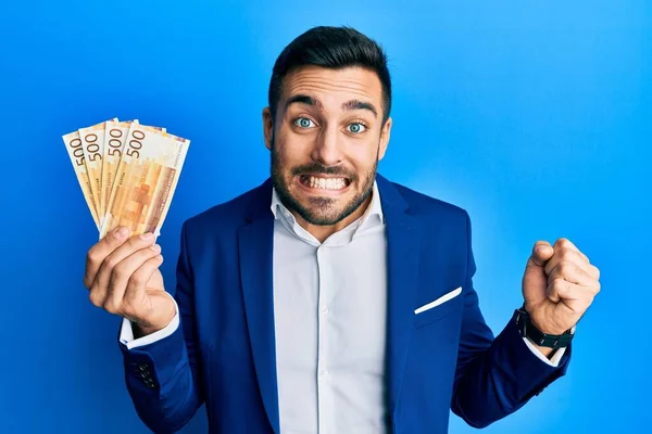 Young Hispanic Businessman Wearing Business Suit Holding Norwegian Krone Banknotes —  Fotos de Stock