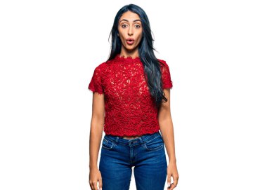 Zarif bir tişört giyen güzel İspanyol kadın. Korkmuş ve ağzı açık kalmış, şaşırmış ve şaşırmış. Şaşırmış. 