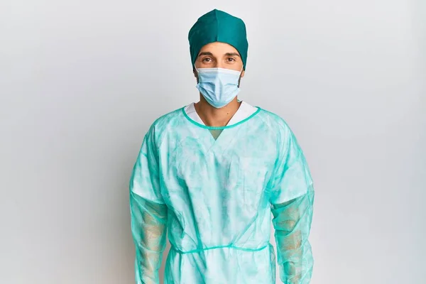 Young Handsome Man Wearing Surgeon Uniform Medical Mask Sticking Tongue — Stock Fotó