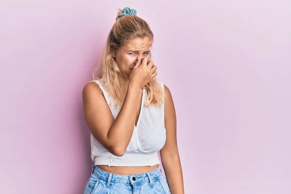 Young Blonde Girl Wearing Casual Clothes Smelling Something Stinky Disgusting — Stock Photo, Image