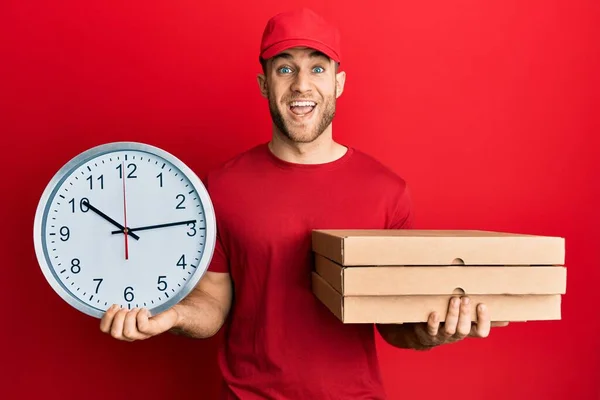 Young Caucasian Man Holding Delivery Package Clock Celebrating Crazy Amazed — Stock Fotó