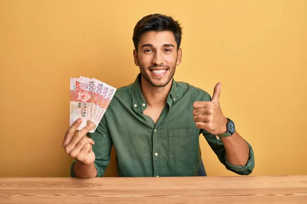 Young Handsome Man Holding Hong Kong Dollars Banknotes Smiling Happy — Stockfoto