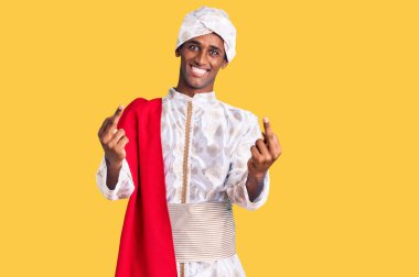 African handsome man wearing tradition sherwani saree clothes showing middle finger doing fuck you bad expression, provocation and rude attitude. screaming excited 