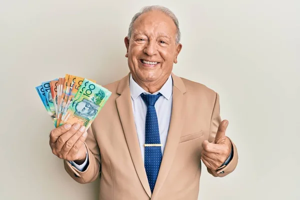 Hombre Caucásico Mayor Sosteniendo Dólares Australianos Sonriendo Feliz Positivo Pulgar —  Fotos de Stock