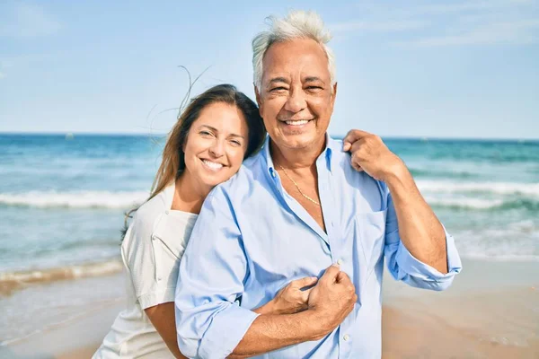 Latynoska Para Średnim Wieku Uśmiecha Się Szczęśliwa Przytula Spacerując Plaży — Zdjęcie stockowe