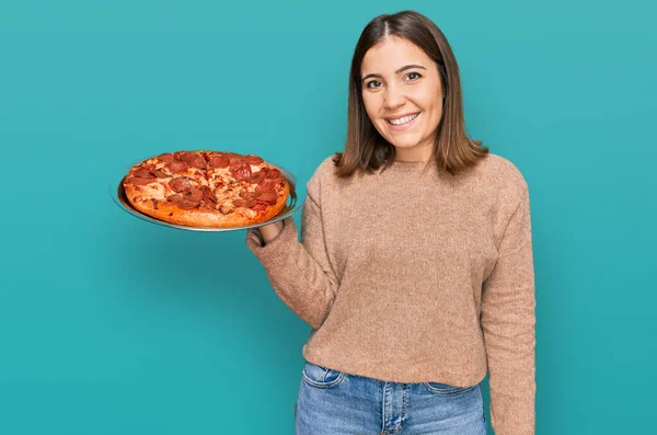 Young Beautiful Woman Holding Italian Pizza Looking Positive Happy Standing — Fotografia de Stock