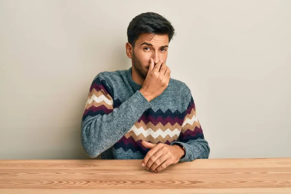 Young Handsome Man Wearing Casual Sweater Sitting Table Smelling Something — Fotografia de Stock