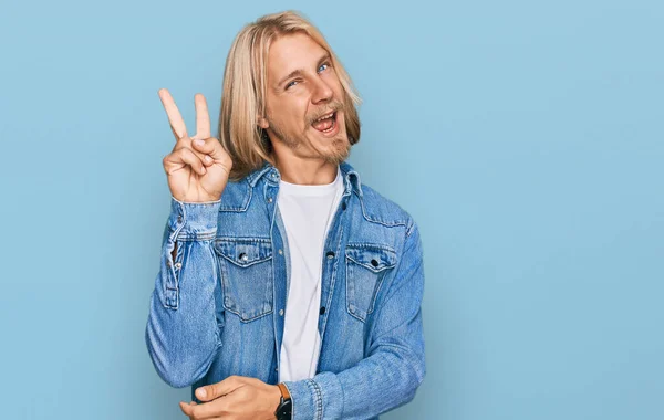 Caucasian Man Blond Long Hair Wearing Casual Denim Jacket Smiling — Zdjęcie stockowe