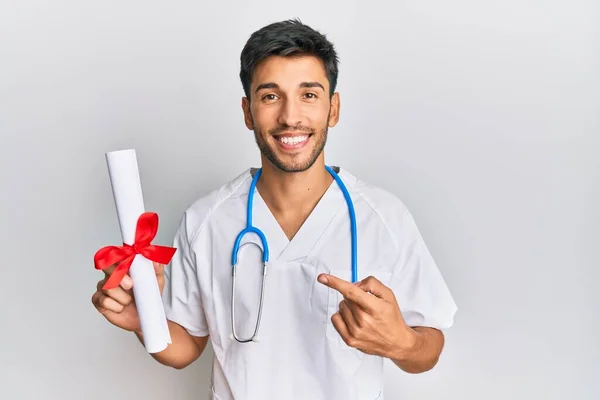 Young Handsome Man Wearing Doctor Uniform Holding Medical Degree Smiling — Stok fotoğraf