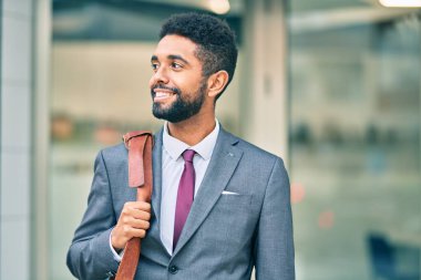 Genç Afrikalı Amerikalı iş adamı şehirde mutlu mesut dikiliyor..