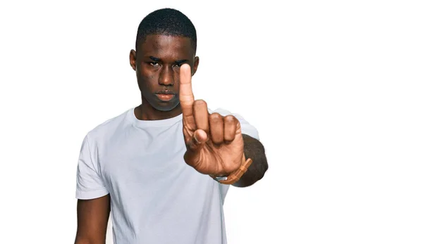 若いアフリカ系アメリカ人の男性は 指を上げて怒りの表情で指差すカジュアルな白いTシャツを着て ジェスチャーを示さない — ストック写真