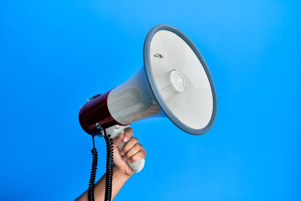 Mão Homem Hispânico Segurando Megafone Sobre Fundo Azul Isolado — Fotografia de Stock