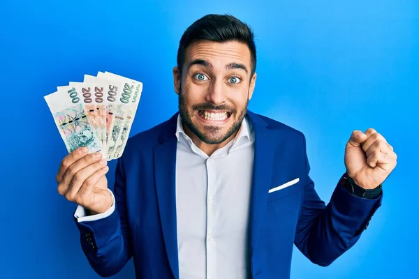 Young Hispanic Businessman Wearing Business Suit Holding Czech Koruna Banknotes — Stock Photo, Image